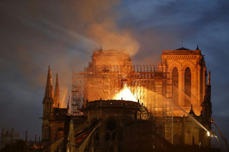 Firefighters douse flames billowing from the roof at Notre-Dame Cathedral in Paris on April 15, 2019.